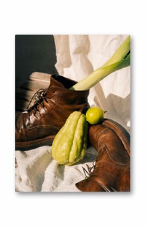 Rustic Still Life with Leather Boots, Chayote, Lime, Leek, and Potato