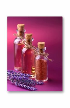 A vibrant still life of glass bottles with copper flakes lavender oil and decorative twine