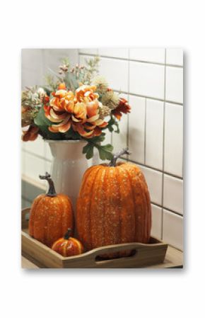 Beautiful still life of pumpkin and flowers in a jug.