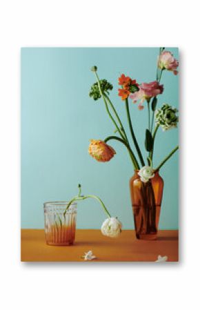 Vertical still life composition on colorful flower bouquet in brown glass vase against light bluish green wall background