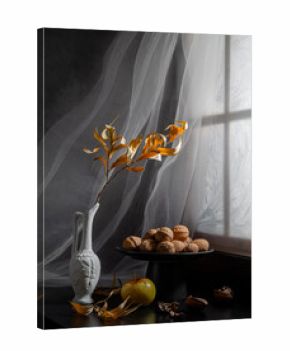 Winter still life with dry willow branch and walnuts on the windowsill