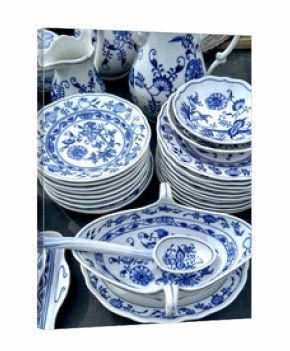 stack of blue and white porcelain plates and dishes on table