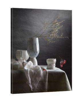 Modern still life with a dry branch in a porcelain vase on a dark background