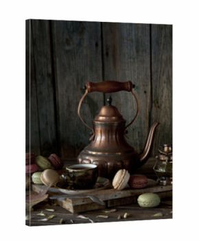 Vintage copper coffee pot, cup of black coffee and colorful macaroons on rustic wooden background. Autumn still life
