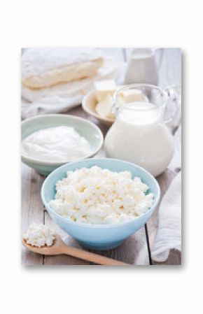 Organic Farming Cottage cheese in a blue bowl, sour cream, butter, cheese and milk