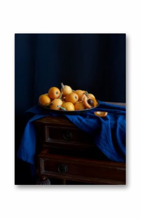 Still life with fresh medlar on the metallic plate