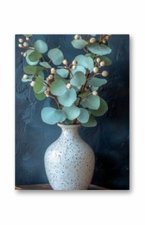 Eucalyptus stems in vase on book