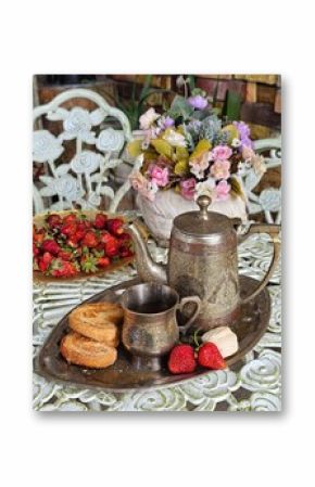 Coffee with cookies and strawberries on a white table