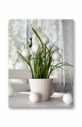 Decorative artificial plant in a pot on the kitchen table