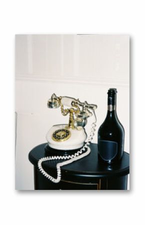 Vintage Telephone and Wine Bottle on a Table 