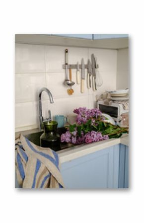  a bouquet of lilacs lies on the kitchen table