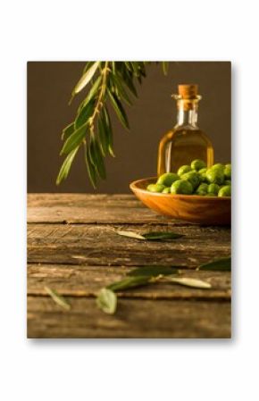 Fresh olives and oil on rustic wood