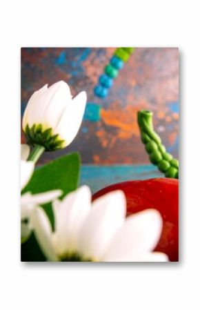 Close-up of white flowers and a red object