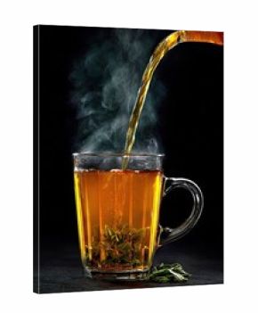 Steaming tea being poured into a glass mug