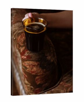 Holding a Glass of Coffee on a Vintage Armchair