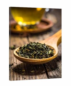 Close-up tea leaves in wooden spoon