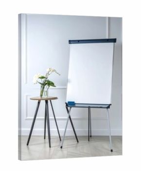 Empty flip chart and small table in a room