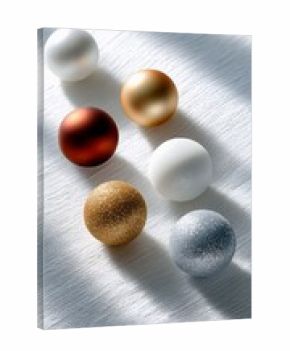 Six spherical Christmas ornaments in various colors and finishes, including white, gold, copper, and silver, are arranged on a textured white fabric surface. Na