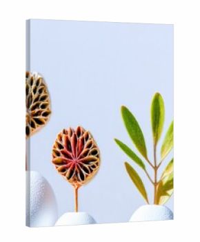 Close-up of dried flowers and green leaves in white vases against a light blue background. The composition is minimalist and artistic.