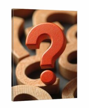 A wooden question mark sits atop a stack of wooden rings, making for a thought-provoking still life