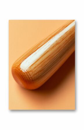 Close-up of a wooden baseball bat on orange background.