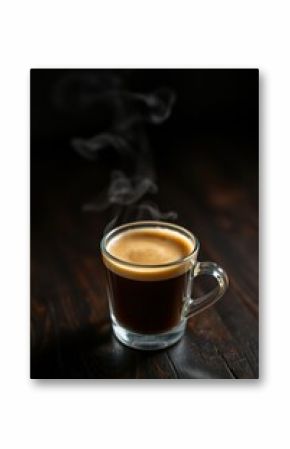 Steaming cup of espresso. Rich coffee in a glass mug on a dark wooden surface. Aromas rise up.