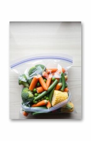 Vegetables in a bag: Fresh broccoli, corn, carrots, peas, and green beans ready for cooking.
