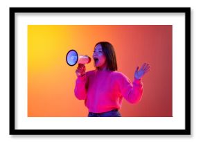 News, information. Young girl in pink sweater talking in megaphone over gradient orange background in neon light. Concept of emotions, facial expression, youth, lifestyle, inspiration, sales, ad