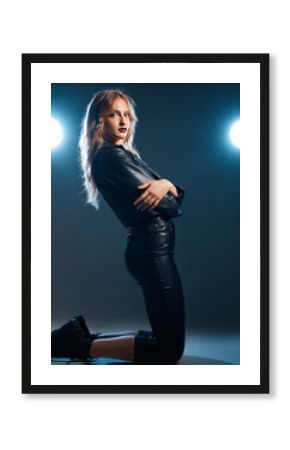 Show, performance and woman portrait of an isolated model or singer with stage lights. Dark background, studio and theatre presentation of a young female dancer ready for creative dance with light