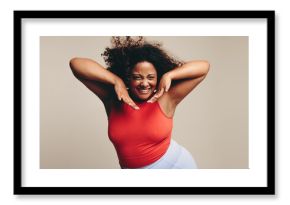 Excited woman moving her fit and curvy body in a fun dance workout