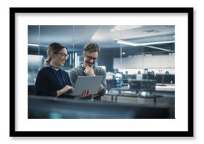 Portrait of Two Creative Young Female and Male Engineers Using Laptop Computer to Analyze and Discuss How to Proceed with the Artificial Intelligence Software. Standing in High Tech Research Office