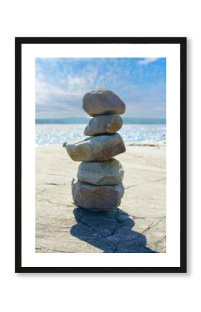 Stacked Rocks balancing, stacking with precision. Stone tower on the shore. Copy space