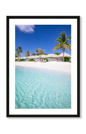 Beach villas in Maldives, luxury summer travel and vacation background. Amazing blue sea and palm trees under blue sky. Tropical landscape and exotic beach. Summer holiday or honeymoon destination