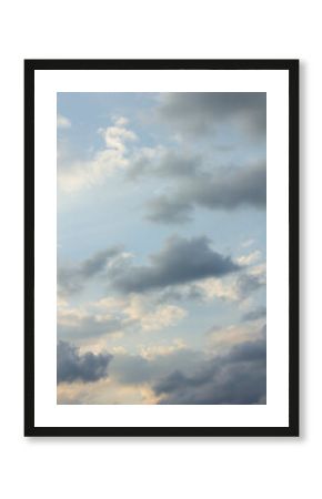 It's a blue sky with atmospheric puffy clouds.