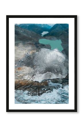 Aerial view of the Fellaria glacier in Valmalenco, Sondrio, Lombardy. Italy. Ice cliff, rock face with waterfalls and lake. Marson glaciological trail. Climate change, melting glaciers