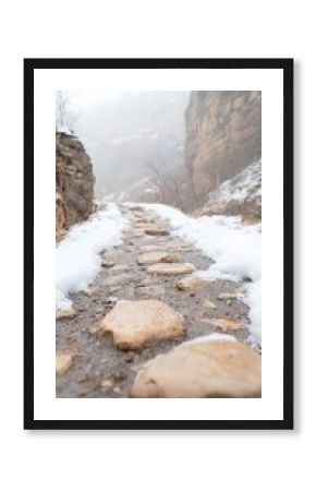 Snowy Stone Path Through a Misty Mountain Valley