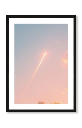 Solitary Airplane Contrail Across Blue and Pink Dawn Sky