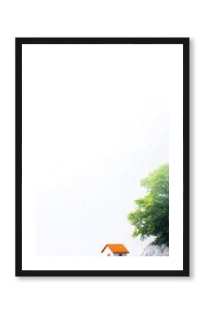 Small House by the Sea Cliff on a Misty Day