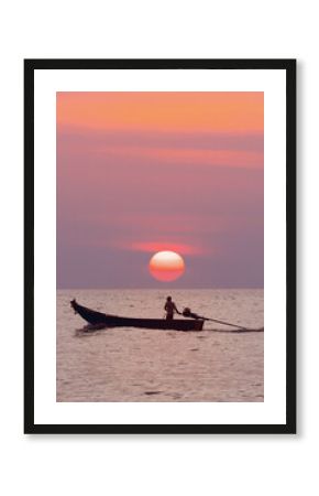 a lone fisherman on a traditional Thai longtail boat sailing on the sea under the setting orange sun. The concept for marketing travel and excursions is Beautiful marine