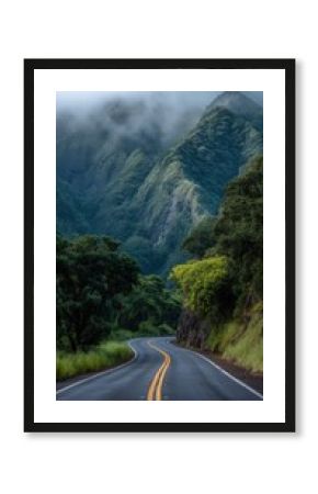 A wet asphalt road with yellow lines stretches into dense tropical greenery and dramatic mist-covered mountains in Hawaii after rainfall.