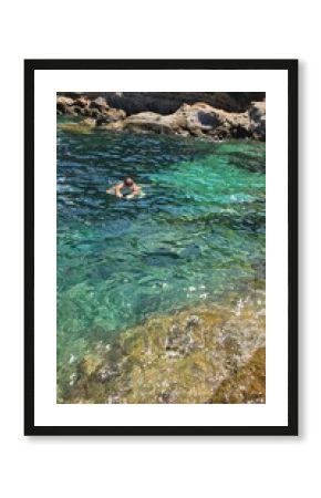 ragazzo fa snorkeling nella baia del mediterraneo