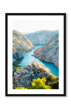View of the Zrmanja River Canyon in Croatia, with winding turquoise waters cutting through limestone cliffs. A scenic natural wonder popular for kayaking and hiking