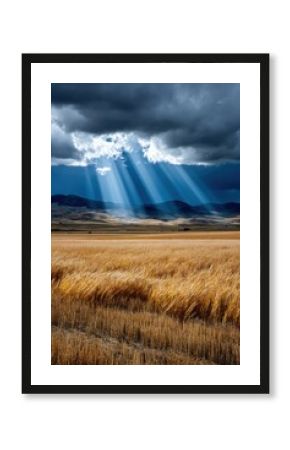 Stunning light rays breaking through dark clouds over golden fields in a rural landscape