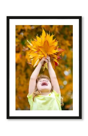 Autumn kid portrait in fall leaf park. Cute child face in autumn outdoors with happy expression. Kid enjoying autumn day with yellow maple and oak leaves. Autumn season for kids fun and emotions.