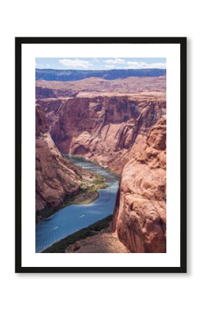 Horseshoe Bend offers a classic aerial view, presenting the iconic U shaped curve of the Colorado River carving through the monumental sandstone cliffs of a desert canyon landscape