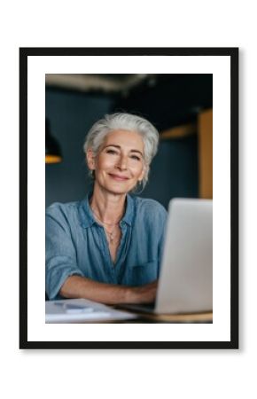 smiling mature middle aged business woman using laptop working on computer sitting at desk happy old businesswoman hr holding cv interviewing distance applicant senior seeker searching job online no 