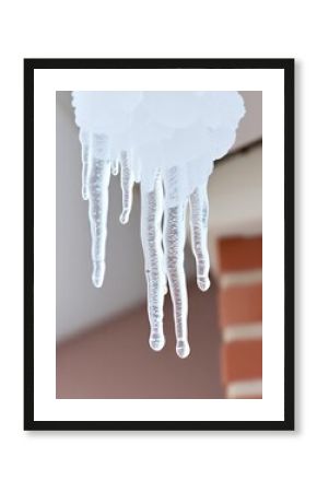  icicles hanging from a roof in front of a building.