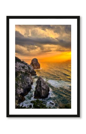  Sunset Over Dramatic Cliffs at Cape Roca, Portugal Description: Stunning view of golden sunset casting warm light on the steep cliffs and ocean at Cape Roca, the westernmost point of continental Euro