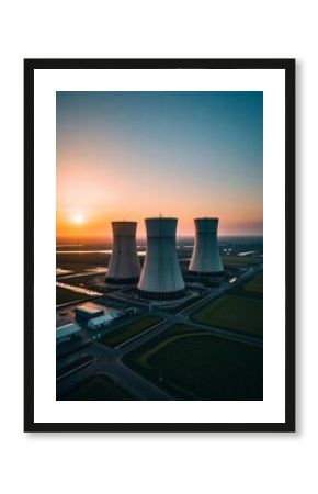 a view of a nuclear power plant with a sunset in the background