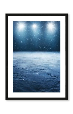 Snowy landscape with bright light shining down on the ground during a winter night with falling snow in a cold environment